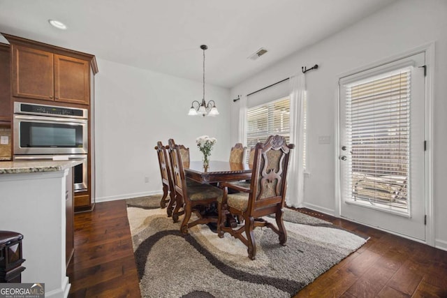 dining space with dark wood-style floors, visible vents, baseboards, an inviting chandelier, and recessed lighting