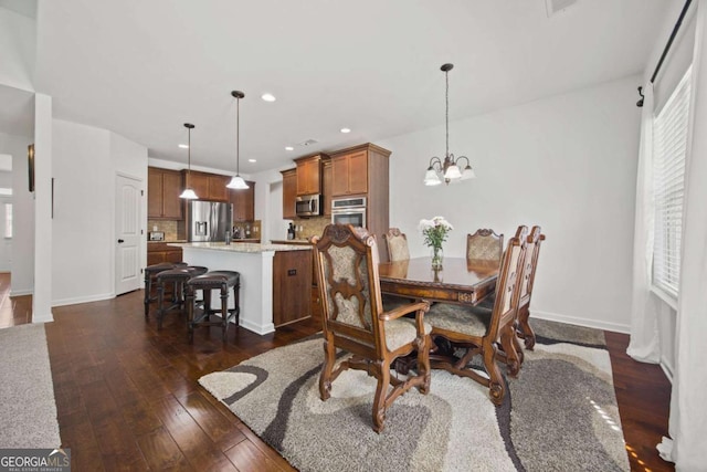 dining space featuring recessed lighting, a notable chandelier, plenty of natural light, and dark wood-type flooring