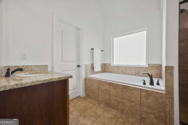 full bathroom with vanity, tile patterned floors, and a bath