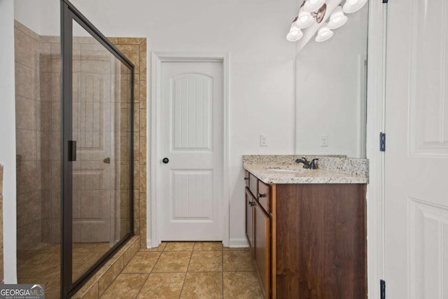 bathroom featuring vanity, a shower stall, and tile patterned flooring