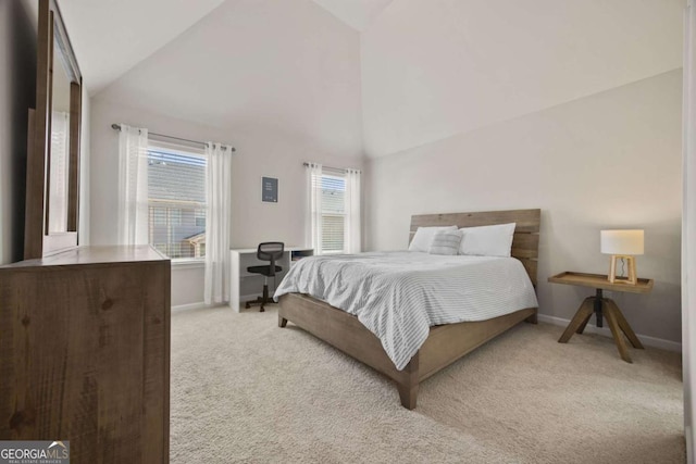 bedroom featuring carpet, baseboards, and high vaulted ceiling