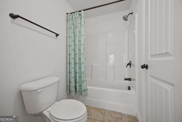 bathroom featuring tile patterned flooring, shower / bath combination with curtain, and toilet