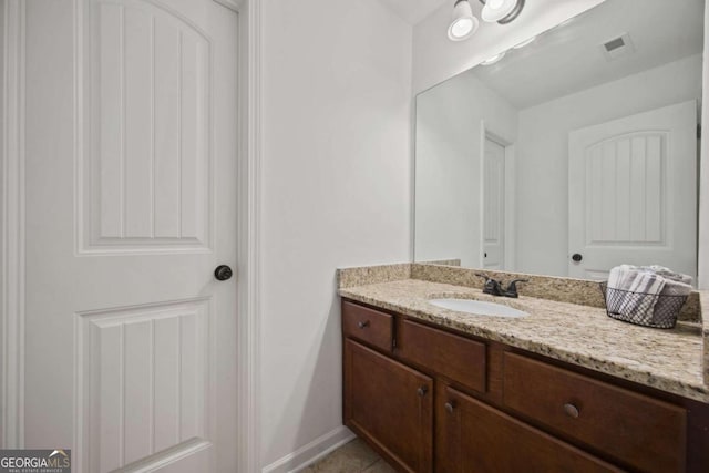 bathroom with tile patterned floors, visible vents, baseboards, and vanity