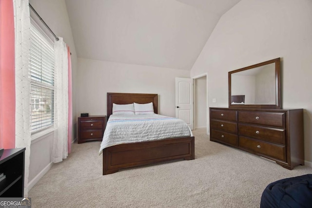 carpeted bedroom with baseboards and vaulted ceiling