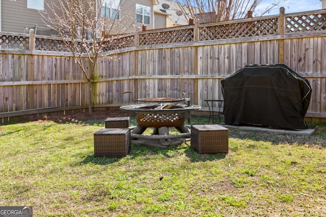 view of yard featuring a fire pit and fence