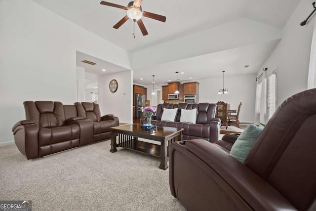 carpeted living area with visible vents, baseboards, vaulted ceiling, recessed lighting, and a ceiling fan