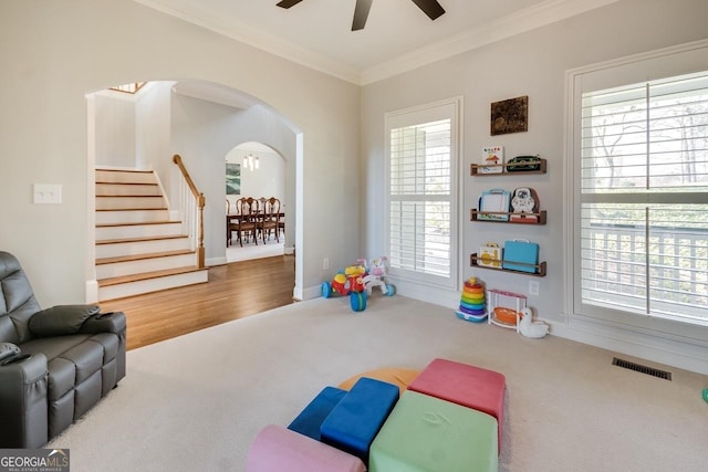 game room with visible vents, carpet flooring, a healthy amount of sunlight, and ornamental molding