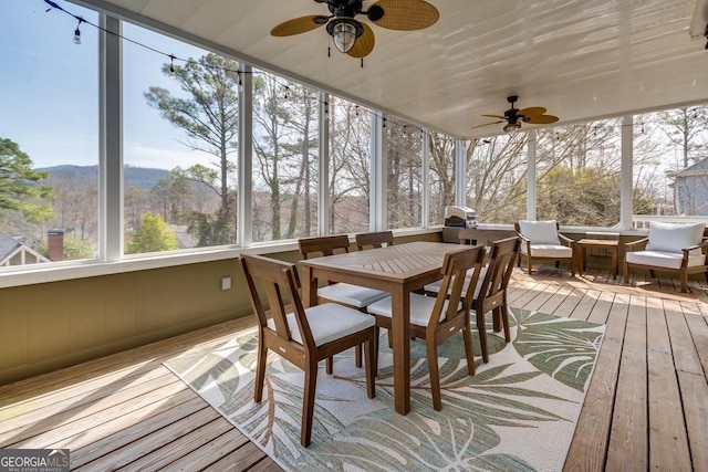 sunroom / solarium with a ceiling fan