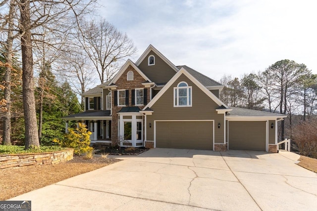 craftsman-style house with concrete driveway and a garage