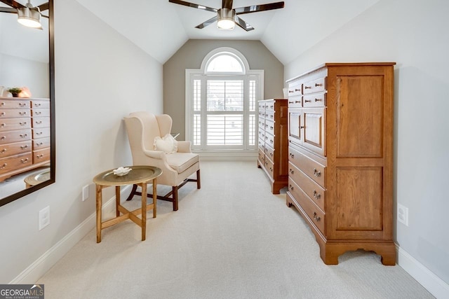 living area with baseboards, light colored carpet, ceiling fan, and vaulted ceiling