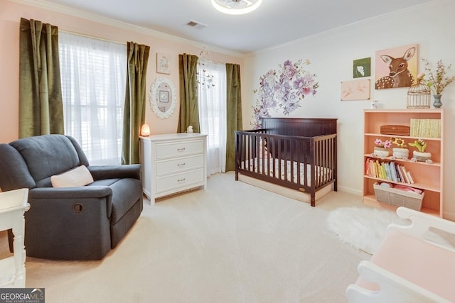 bedroom featuring a nursery area, carpet, visible vents, and ornamental molding