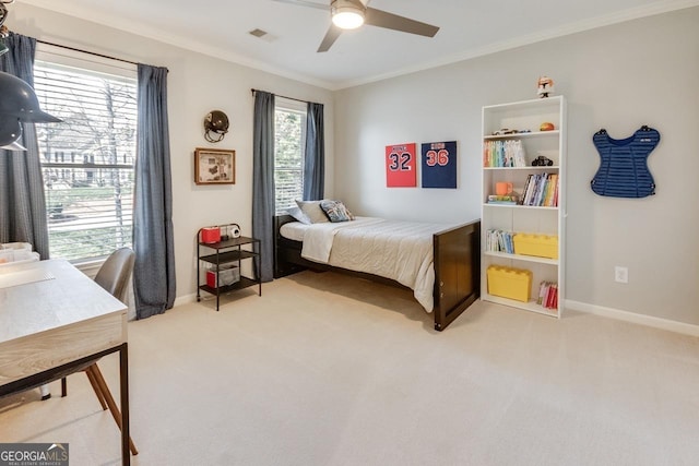 bedroom with visible vents, light colored carpet, crown molding, and baseboards