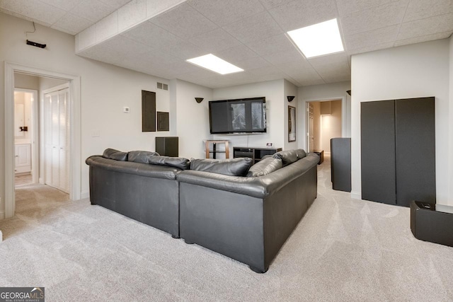 living area featuring a drop ceiling, visible vents, elevator, and carpet flooring