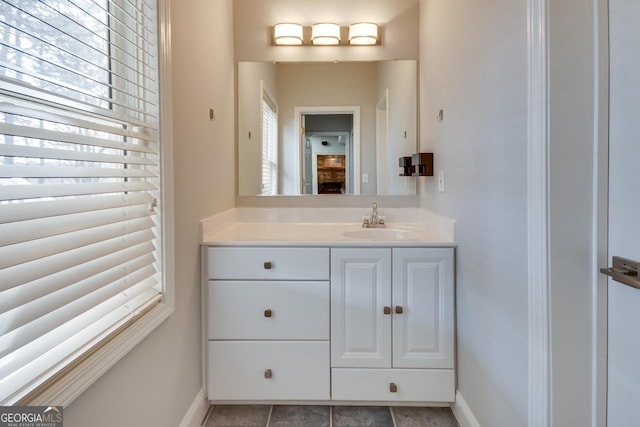 bathroom featuring tile patterned flooring, vanity, and baseboards