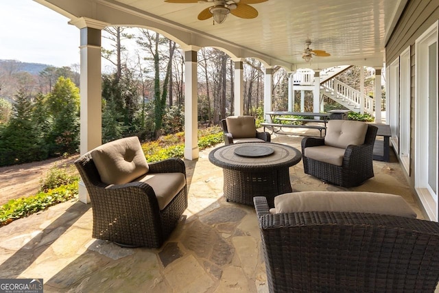 view of patio with stairs, an outdoor living space, and ceiling fan