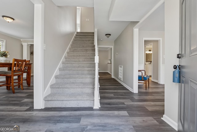staircase with baseboards and wood finished floors