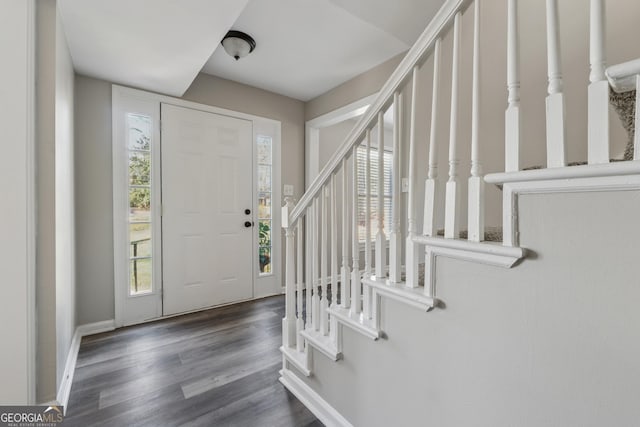 staircase with wood finished floors and baseboards