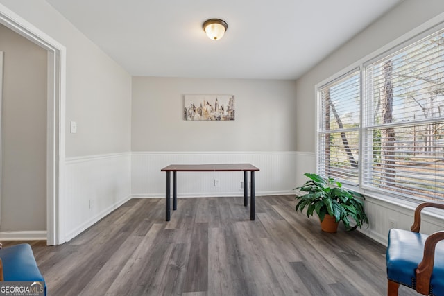 living room with dark wood finished floors, built in features, a brick fireplace, and baseboards