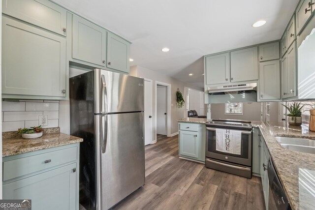unfurnished room featuring wood finished floors and wainscoting
