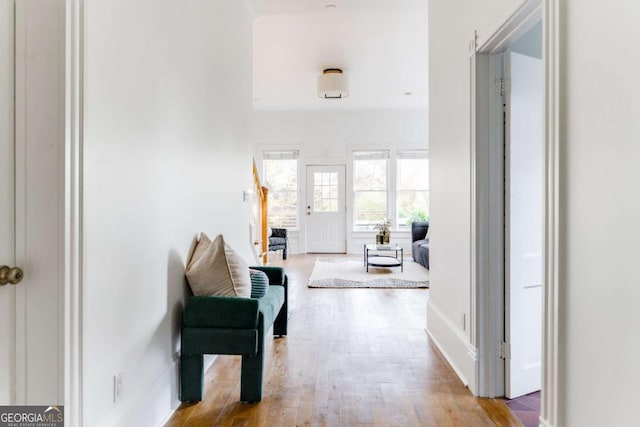 hall featuring baseboards and wood finished floors