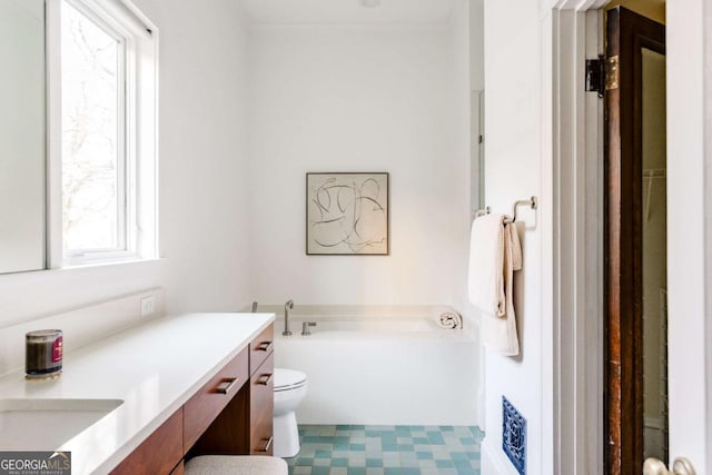 bathroom with tile patterned floors, toilet, a bath, and vanity