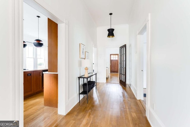 corridor featuring plenty of natural light and light wood finished floors