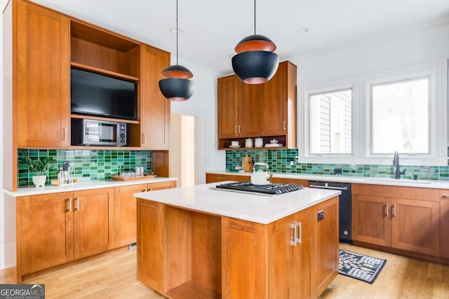 kitchen with open shelves, light countertops, appliances with stainless steel finishes, and a sink