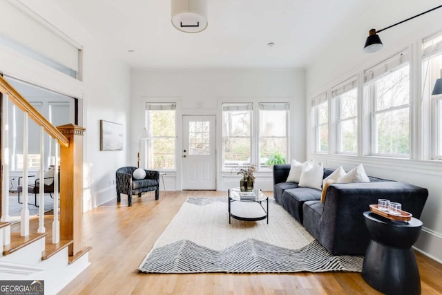 living room featuring stairway and light wood-style flooring