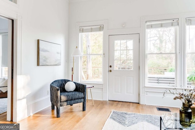 entrance foyer featuring wood finished floors, visible vents, and a wealth of natural light