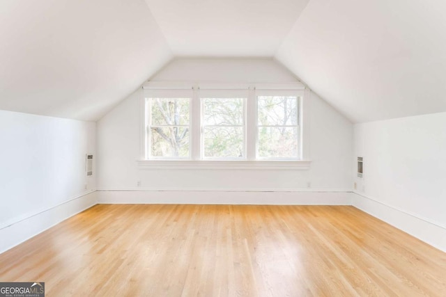 additional living space with lofted ceiling and wood finished floors