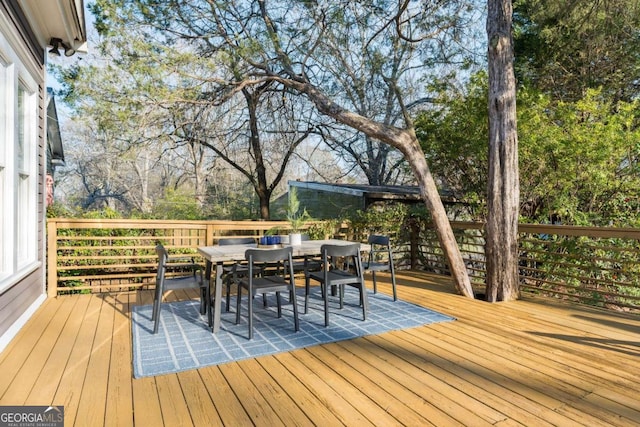 wooden terrace with outdoor dining area