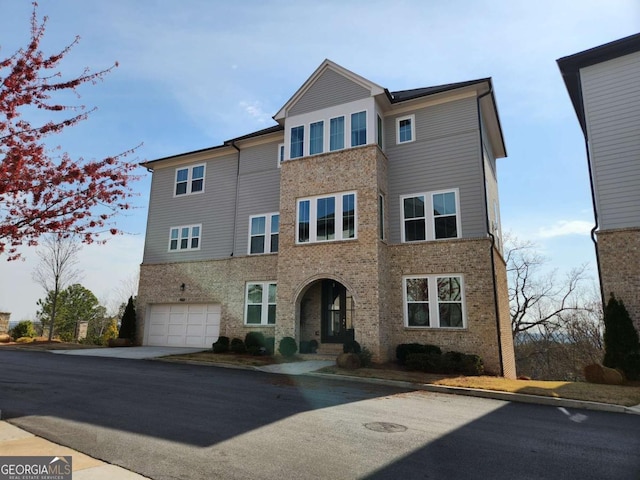 view of front of home with a garage and brick siding