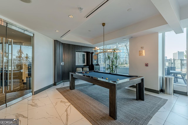 game room with marble finish floor, pool table, a raised ceiling, and baseboards