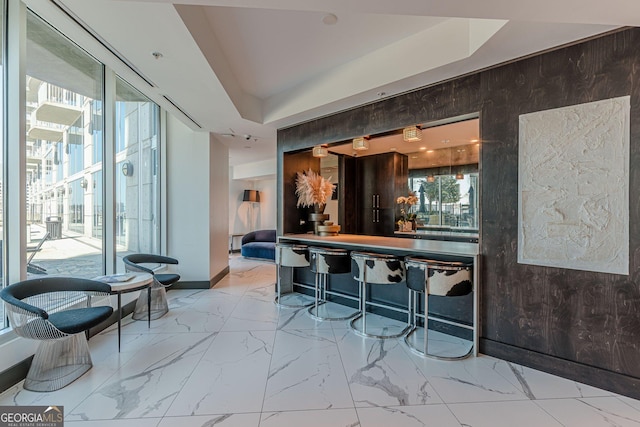 bar with marble finish floor and wood walls