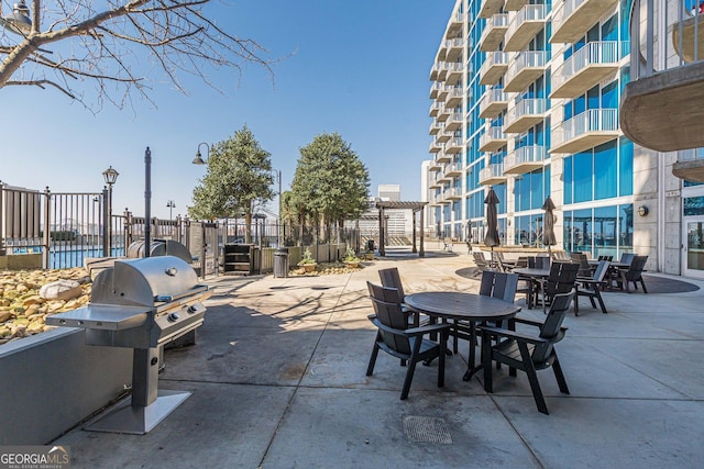 view of patio featuring grilling area and fence