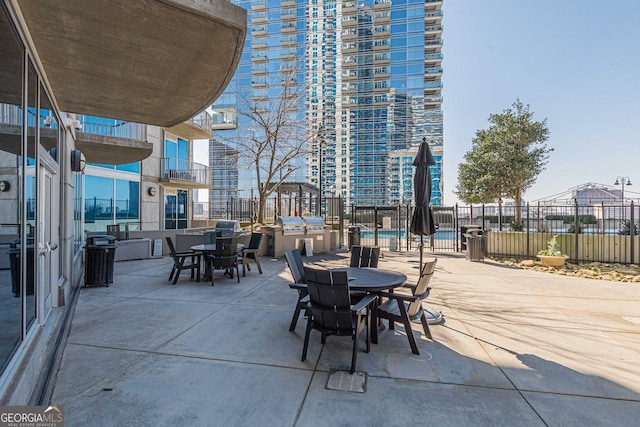 view of patio / terrace with outdoor dining area and fence