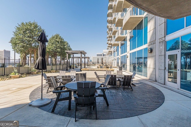 view of patio / terrace with outdoor dining area and fence