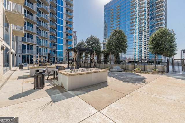 view of community with a patio and fence