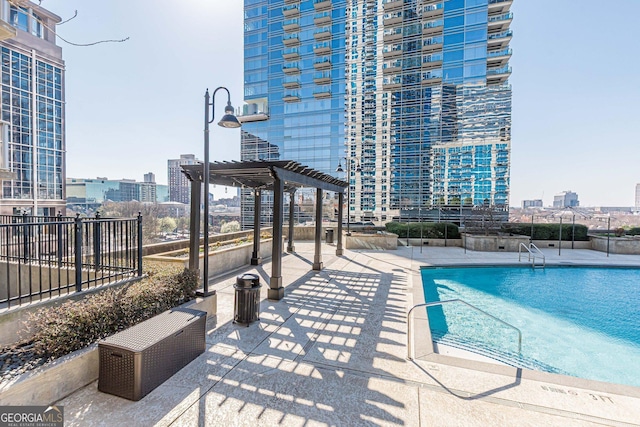 pool with a city view, a patio area, and a pergola