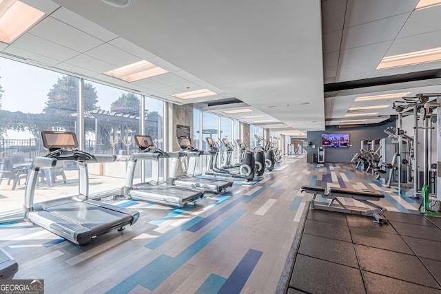 gym with carpet and floor to ceiling windows