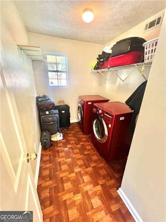 3672 Misty Oak Dr, Flowery Branch, GA 30542 - laundry room with washer and dryer and a textured ceiling