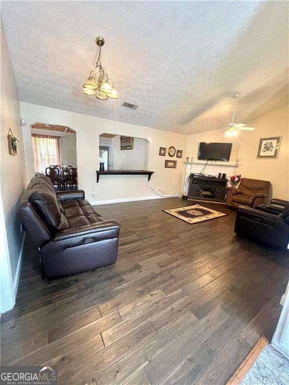 3672 Misty Oak Dr, Flowery Branch, GA 30542 - living area with a textured ceiling, wood finished floors, ceiling fan, lofted ceiling, and a chandelier