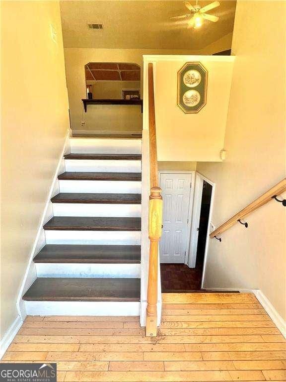 3672 Misty Oak Dr, Flowery Branch, GA 30542 - staircase featuring wood-type flooring and ceiling fan