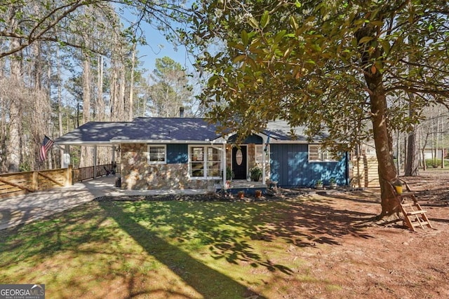 view of front of home with a front lawn, fence, and driveway