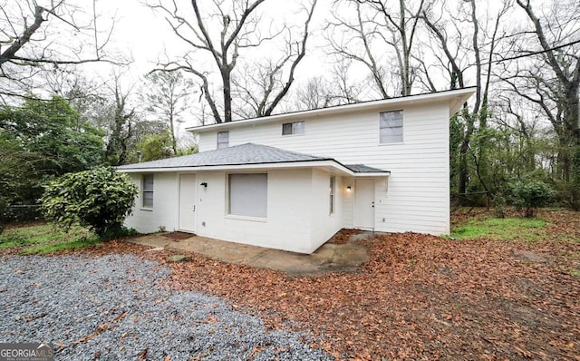 rear view of property with concrete block siding