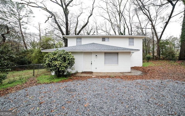 view of front of home featuring fence and a shingled roof