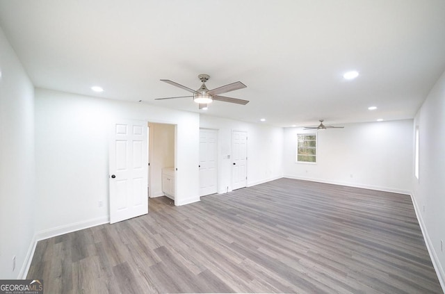 empty room with recessed lighting, a ceiling fan, baseboards, and wood finished floors