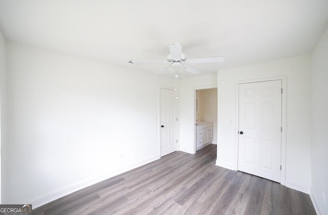 unfurnished bedroom with ceiling fan, baseboards, and wood finished floors