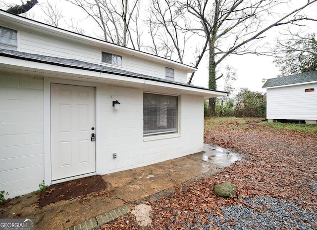 doorway to property featuring concrete block siding