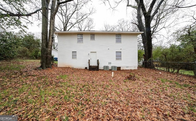 back of house with entry steps and fence